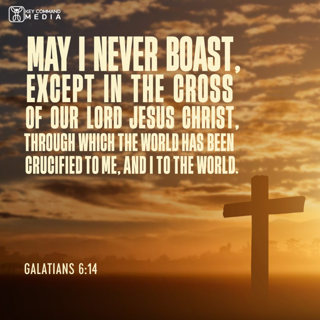 A cross silhouetted against a setting dusk with Galatians 6:14, "May I never boast, except in the cross of our Lord Jesus Christ, through which the world has been crucified to me, and I to the world."