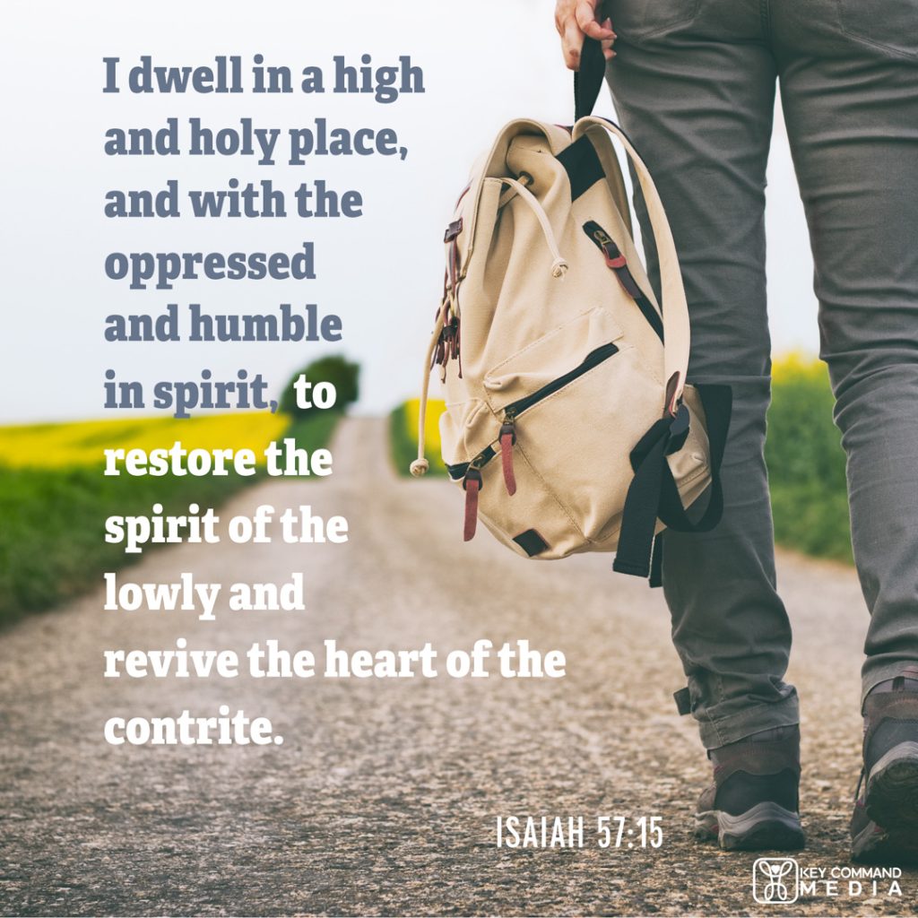 A young man walks a country dirt road carrying a backpack with Isaiah 57:15, "I dwell in a high and holy place, and with the oppressed and humble in spirit, to restore the spirit of the lowly and revive the heart of the contrite."