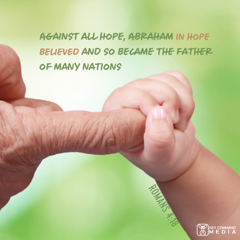A baby's hand curls around one finger of an elderly person with Romans 4:18, "Against all hope, Abraham in hope believed and so became the father of many nations."