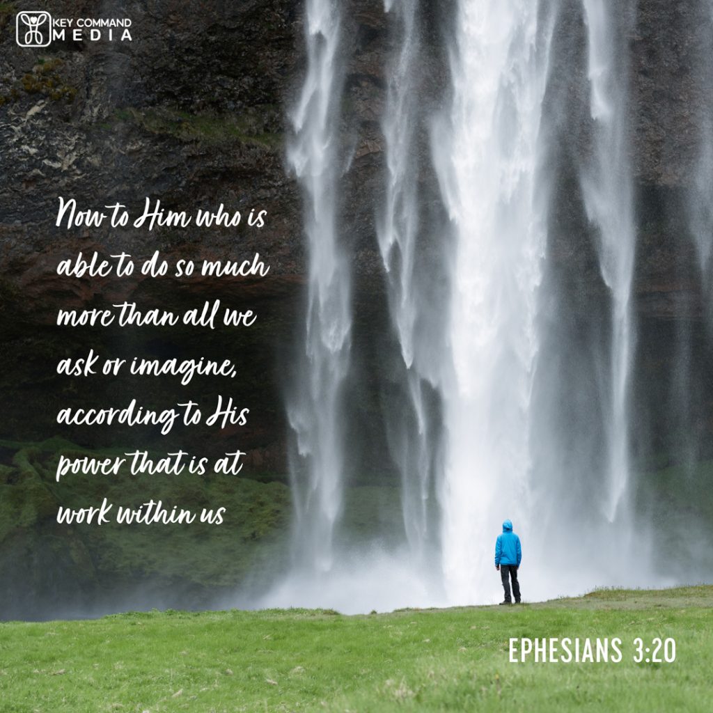 A huge waterfall dwarfs a person in a blue hooded jacket looking up at it with Ephesians 3:20, "Now to Him who is able to do so much more than all we ask or imagine, according to His power that is at work within us."