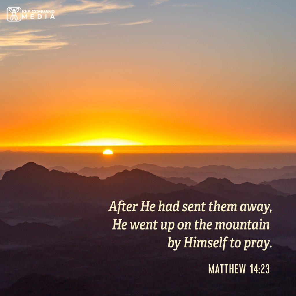 The sun sets in the orange sky in the distance from a view overlooking several mountains with Matthew 14:23, "After He had sent them away, He went up on the mountain by Himself to pray."