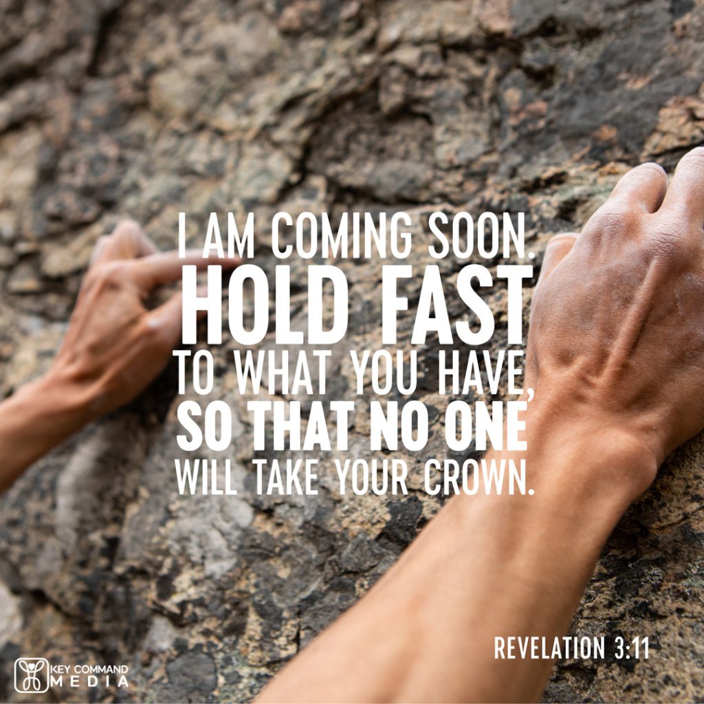 A closeup of a rock climber's hand gripping a rock face with Revelation 3:11, "I am coming soon. Hold fast to what you have, so that no one will take your crown."