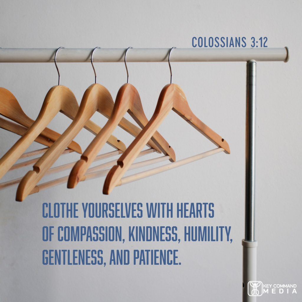 Empty wooden clothes hangers are on a clothing rack with Colossians 3:12, "Clothe yourselves with hearts of compassion, kindness, humility, gentleness, and patience."