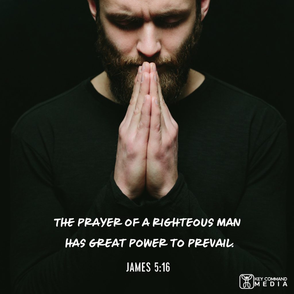 A bearded man holds his hands together in front of his face with head bowed in prayer with James 5:16, "The prayer of a righteous man has great power to prevail."