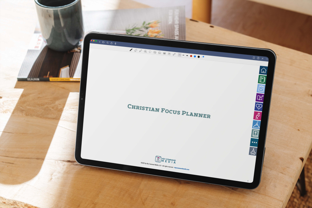 The Christian Focus Planner cover page is displayed on an upright iPad Pro on a wooden table with a cup of coffee in the background